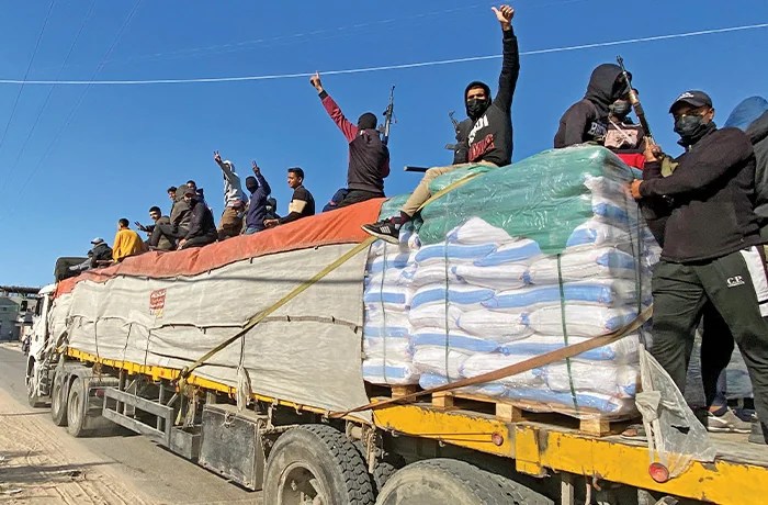 Armed Hamas fighters ride atop an aid truck in Rafah, Gaza, Dec. 19, 2023. (Associated Press)