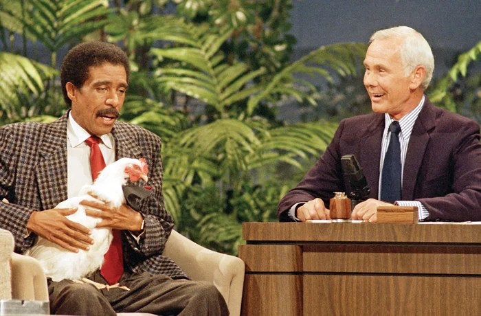 Comedian Richard Pryor holds a chicken while speaking with Johnny Carson on The Tonight Show, Oct. 9, 1986. (Tweed/AP Photo)