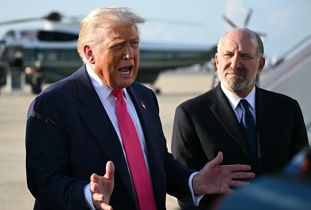 President Donald Trump (L), flanked by US Secretary of Commerce Howard Lutnick, speaks to reporters after stepping off Air Force One upon arrival at Joint Base Andrews, Maryland on July 15, 2025. Trump is returning from Pittsburgh, Pennsylvania, after speaking at the Pennsylvania Energy and Innovation Summit on the campus of Carnegie Mellon University. (Photo by ANDREW CABALLERO-REYNOLDS / AFP) (Photo by ANDREW CABALLERO-REYNOLDS/AFP via Getty Images)
