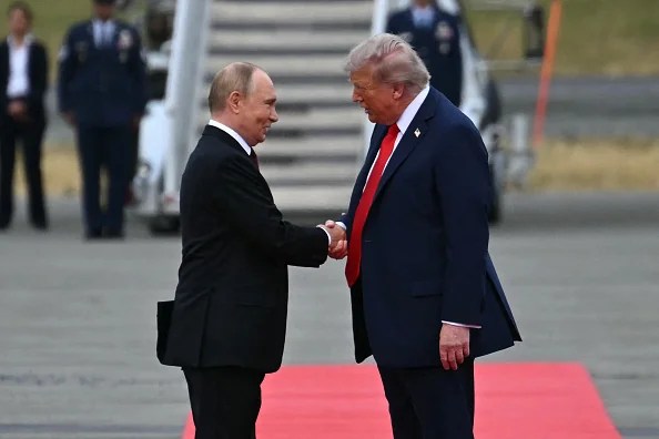 President Donald Trump greets Russian President Vladimir Putin on the tarmac after they arrived at Joint Base Elmendorf-Richardson in Anchorage, Alaska, on August 15, 2025. Putin is in Alaska at the invitation of Trump in his first visit to a Western country since he ordered the 2022 invasion of Ukraine that has killed tens of thousands of people.
