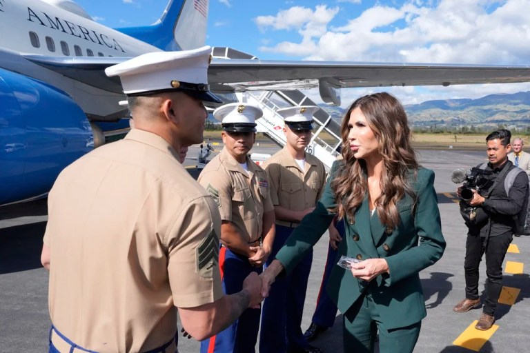 Homeland Security Secretary Kristi Noem speaks with U.S. Marines before boarding her plane to depart the New Mariscal Sucre International Airport, Thursday, July 31, 2025, in Quito, Ecuador.