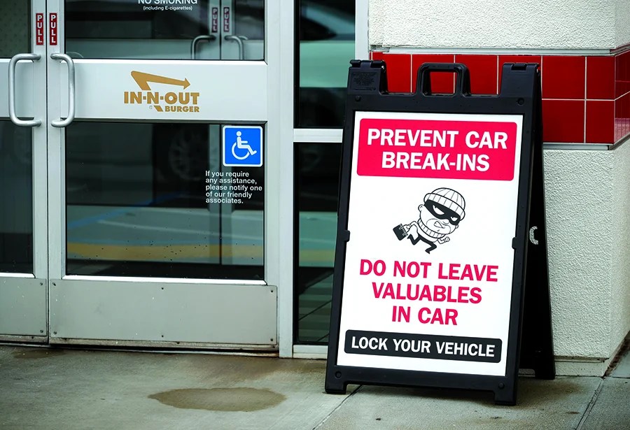 A sign warns patrons of car break-ins at the In-N-Out Burger off Hegenberger Road in Oakland, Calif., on Monday, Jan. 22, 2023. The company is closing its only Oakland restaurant, citing ongoing issues with crime. (Jane Tyska/Digital First Media/East Bay Times via Getty Images)