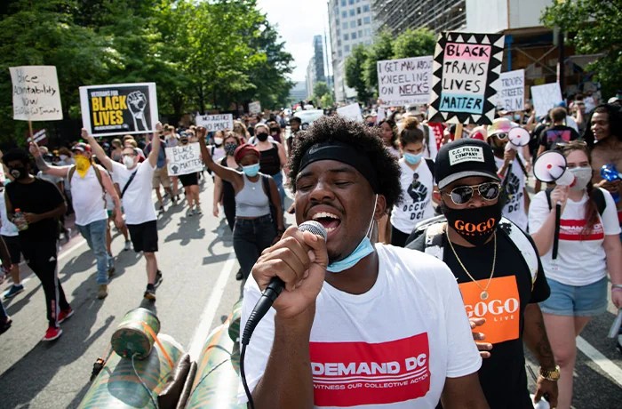 Kevin L. Cramer Jr., an organizer with The Palm Collective, leads a protest against systemic racism in Black Lives Matter Plaza in Washington, D.C., on August 1, 2020, amid the coronavirus pandemic. During a week when President Trump suggested postponing the upcoming election, and the United States passed 150,000 confirmed deaths from COVID-19, protests against racism and police continued into their third month. (Graeme Sloan/Sipa USA via AP)