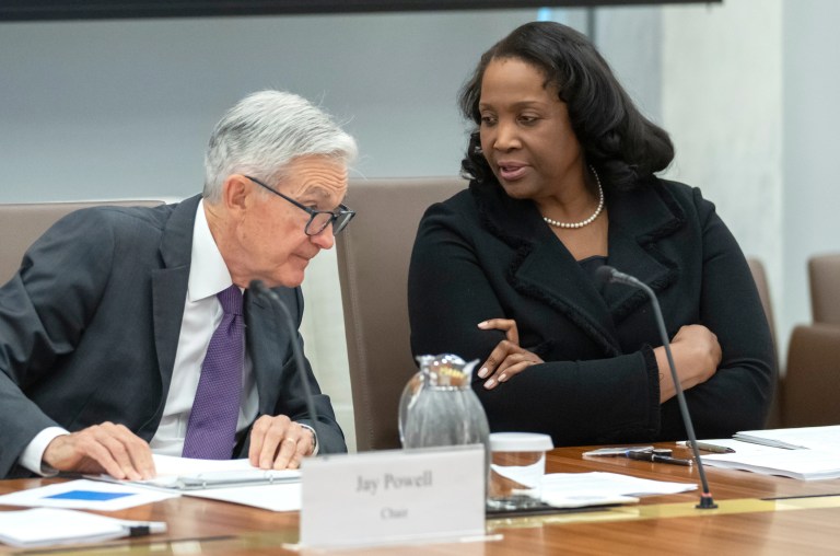 Federal Reserve Board of Governors member Lisa Cook, right, talks with Federal Reserve Chairman Jerome Powell before an open meeting of the Board of Governors at the Federal Reserve, June 25, 2025, in Washington. (AP Photo/Mark Schiefelbein, File)