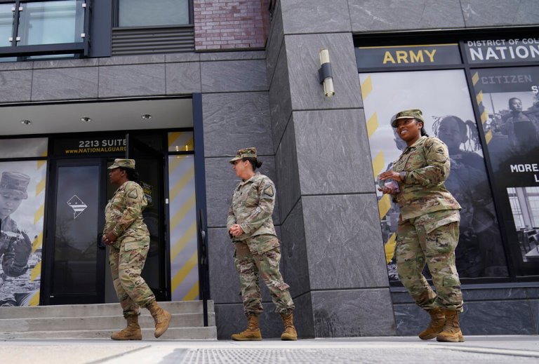 The U.S. Army National Guard members including recruitment chief Lt. Col. Amber Ellison, center, stand outside the Army National Guard office during training, Thursday, April 21, 2022 in Washington. In March the local guard opened its first proper recruiting office in the city since 2010. The commander, Maj. Gen. Sherrie McCandless, describes the move as a new push for visibility and an emphasis on the guard’s local connections at a time when many residents might be ripe for recruitment.