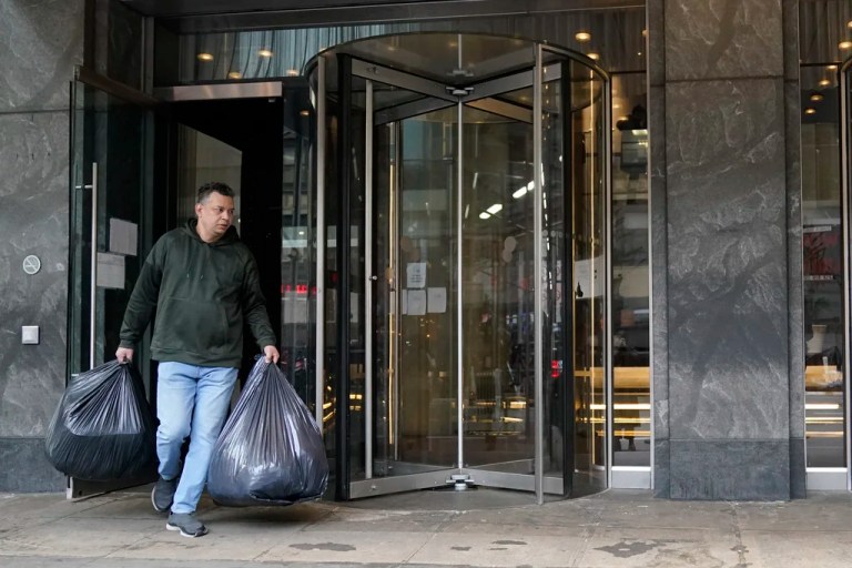 An immigrant from Colombia leaves the Row Hotel with his belongings, Tuesday, Jan. 9, 2024, in New York.