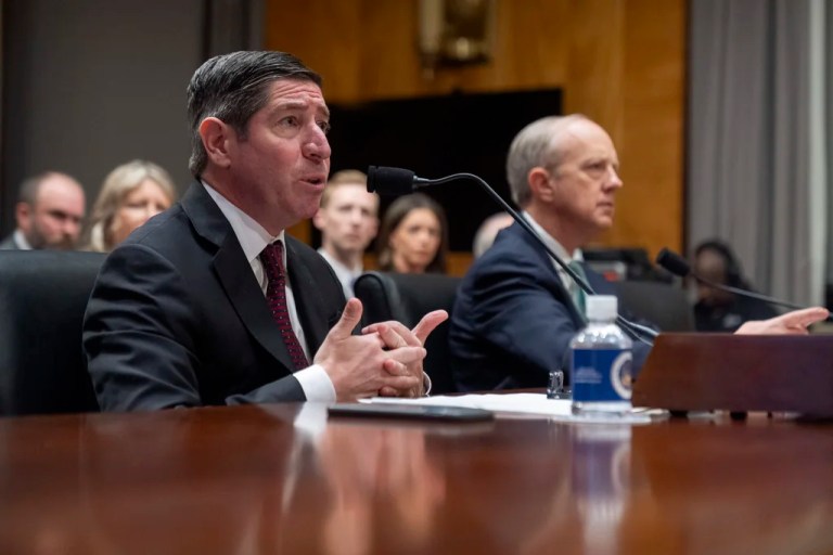 OPM director Scott Kupor, left, speaks during his confirmation hearing in the U.S. Senate.