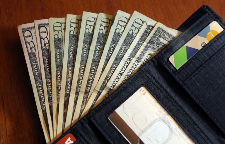In this June 15, 2018, file photo, cash is fanned out from a wallet in North Andover, Massachusetts.