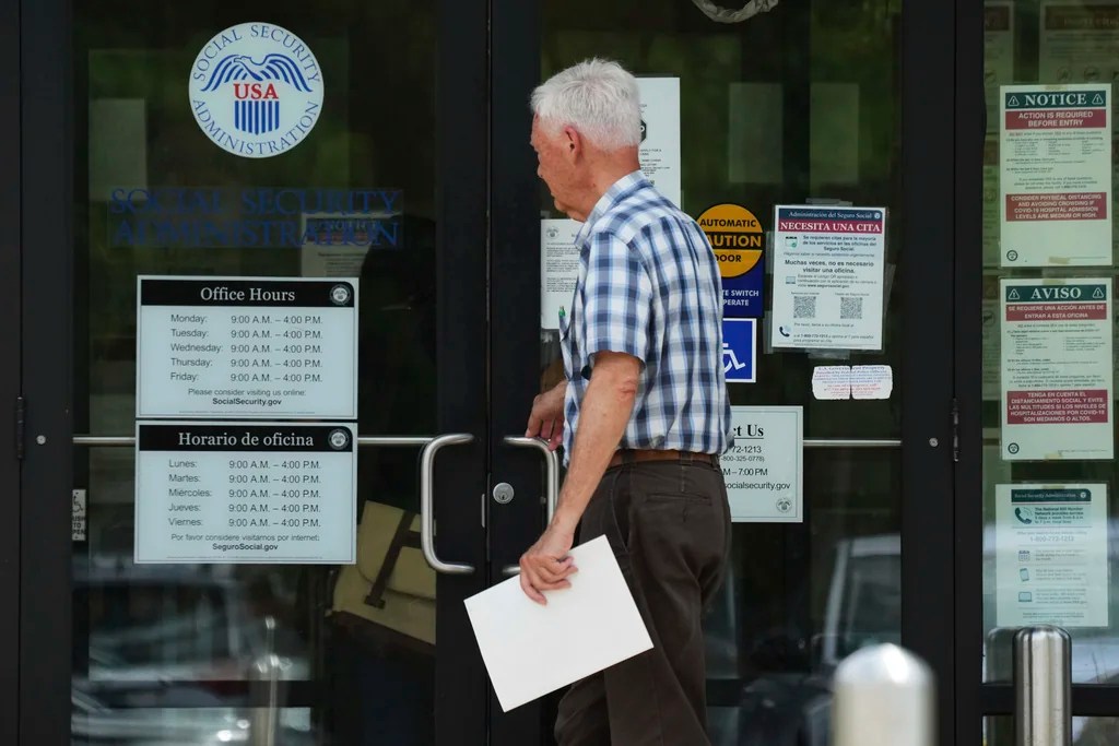 A man walks to a U.S. Social Security Administration office Monday, June 30, 2025, in Mount Prospect, Ill. (AP Photo/Nam Y. Huh)