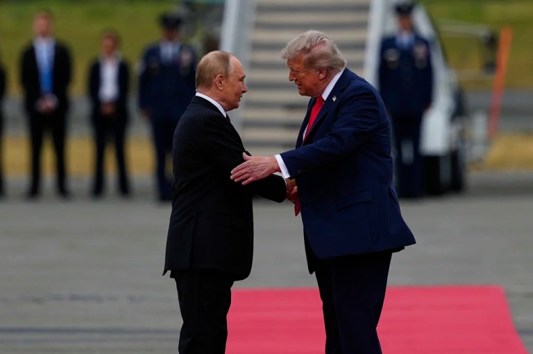 President Donald Trump greets Russian President Vladimir Putin.