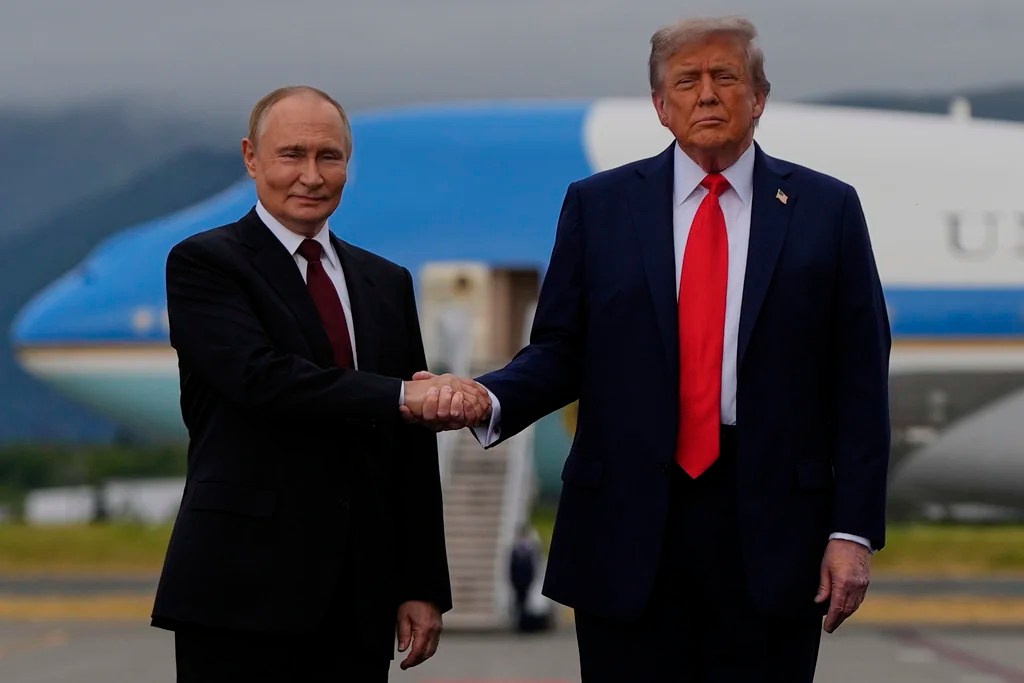 President Donald Trump greets Russia's President Vladimir Putin Friday, Aug. 15, 2025, at Joint Base Elmendorf-Richardson, Alaska. (AP Photo/Julia Demaree Nikhinson)