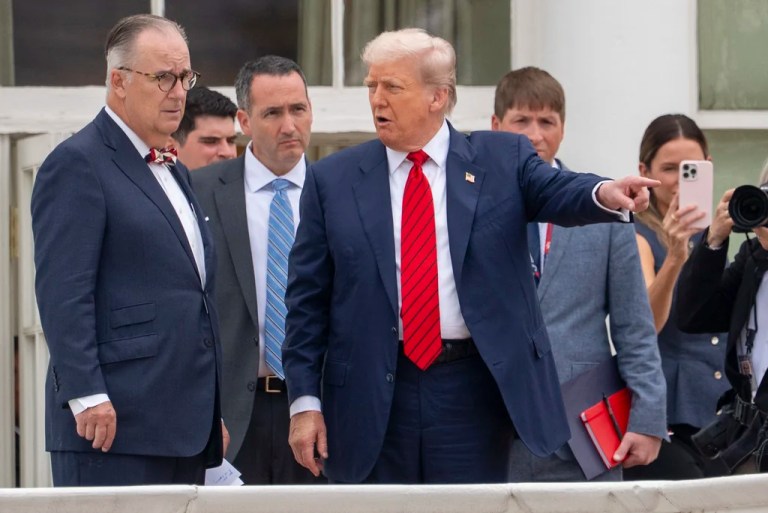 President Donald Trump, center, with architect James McCrery, left, surveys the grounds from the roof above the Colonnade that goes to the West Wing of the White House, Tuesday, Aug. 5, 2025, in Washington. (AP Photo/Alex Brandon)