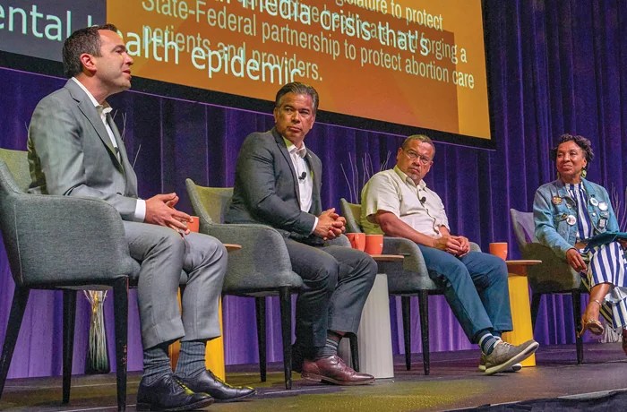 Democratic attorneys general Matthew Platkin (NJ), Rob Bonta (CA), and Keith Ellison (MN) speak with civil rights attorney Kimberlé Crenshaw at the 2025 Netroots Nation progressive political conference in New Orleans, Aug. 8, 2025. (Dominic Gwinn/Middle East Image/AFP via Getty Images)