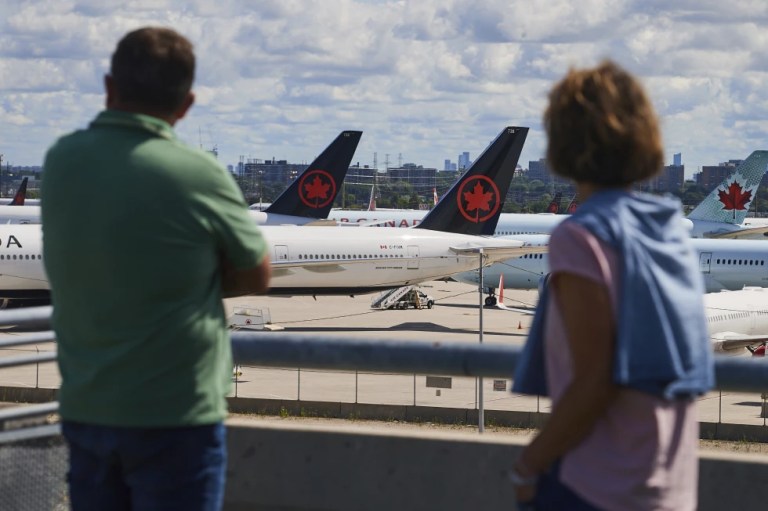 Passengers look at Air Canada planes from Toronto's Pearson Airport.