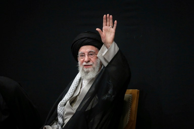 Ayatollah Ali Khamenei waves to the crowd during a ceremony.