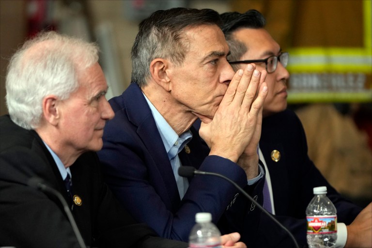 Re. Darrell Issa (R-CA), center, listens as President Donald Trump speaks during a briefing during a tour of the Pacific Palisades neighborhood affected by recent wildfires in Los Angeles, Friday, Jan. 24, 2025.