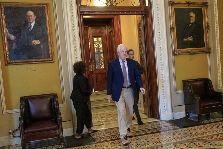 Sen. John Cornyn, (R-TX), center, walks in the Senate on Capitol Hill, Monday, June 30, 2025, in Washington.