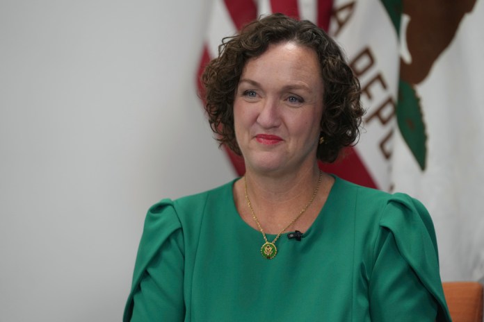 Former Democratic California Rep. Katie Porter smiles.