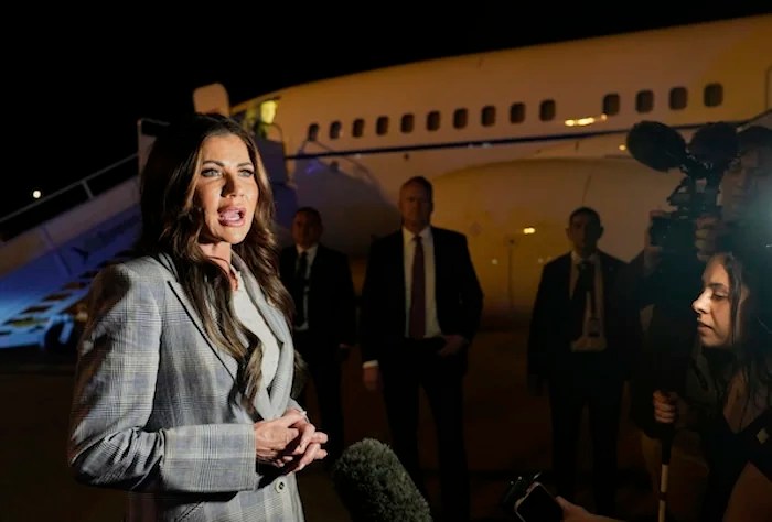 Homeland Security Secretary Kristi Noem takes questions from the press before boarding her plane to Colombia at Comalapa International Airport in San Salvador, El Salvador, Wednesday, March 26, 2025. (AP Photo/Alex Brandon)