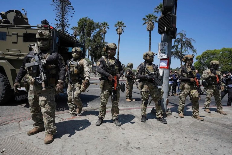 FILE - Federal agents stage at MacArthur Park, July 7, 2025, in Los Angeles. (AP Photo/Damian Dovarganes, File)