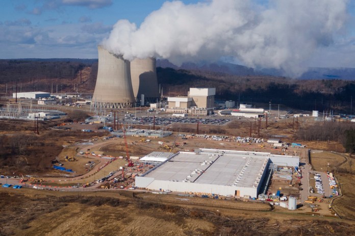 A data center owned by Amazon Web Services, front right, is under construction next to the Susquehanna nuclear power plant.