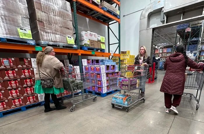 FILE - Shoppers guide their carts through the milk display in a Costco warehouse Thursday, Jan. 23, 2025,