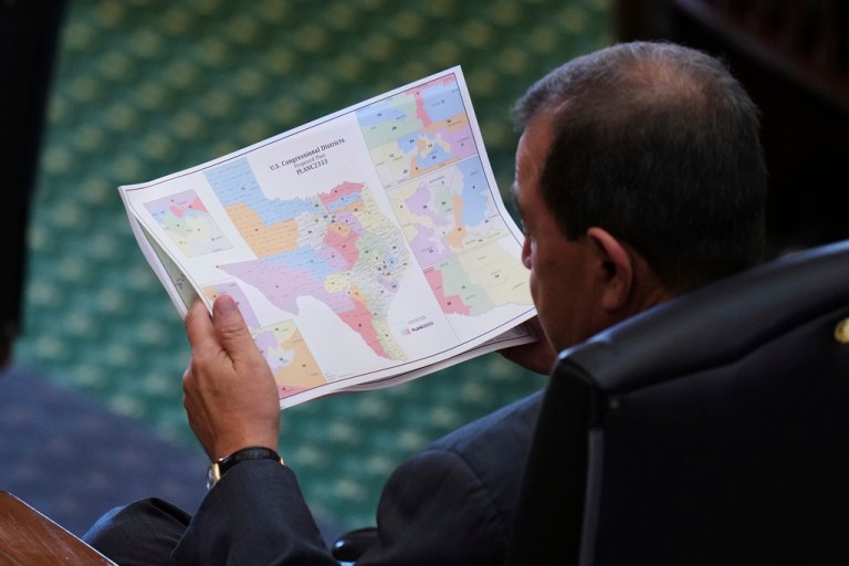 Republican Texas state Sen. Pete Flores looks at a redrawn congressional map.