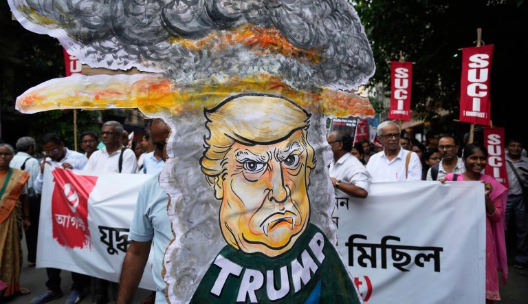 Supporters of Socialist Unity Centre of India-Communist shout slogans against American imperialism as they walk with posters and an effigy of U.S. President Donald Trump to mark the 80th anniversary of atomic bombing of Hiroshima during the World War II, in Kolkata, India, Wednesday, Aug. 6, 2025. (AP Photo/Bikas Das)