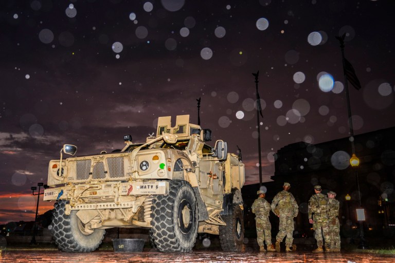 Members of the D.C. National Guard stand next to their M-ATV outside Union Station, Sunday, Aug. 17, 2025, in Washington.