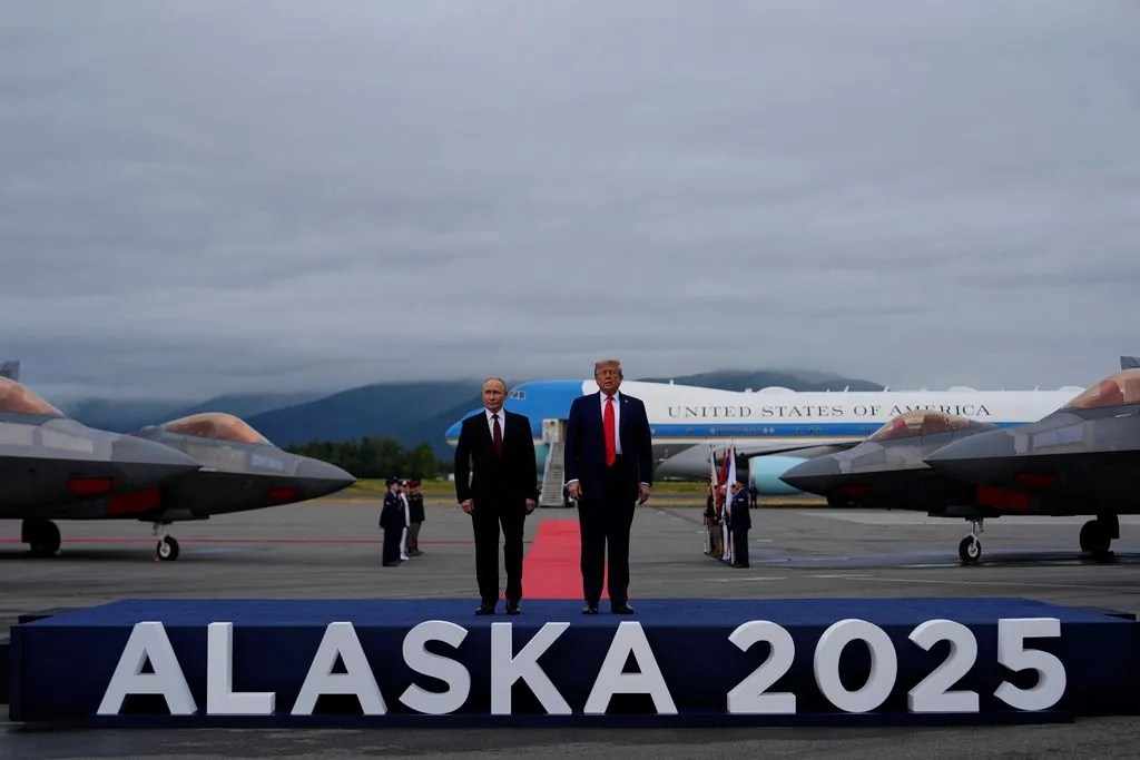 President Donald Trump greets Russia's President Vladimir Putin Friday, Aug. 15, 2025, at Joint Base Elmendorf-Richardson, Alaska. (AP Photo/Julia Demaree Nikhinson)