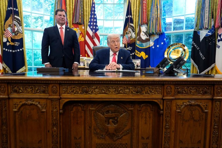 President Donald Trump speaks as Social Security Commissioner Frank Bisignano listens during an event in the Oval Office to mark the 90th anniversary of the Social Security Act, Thursday, Aug. 14, 2025, in Washington.