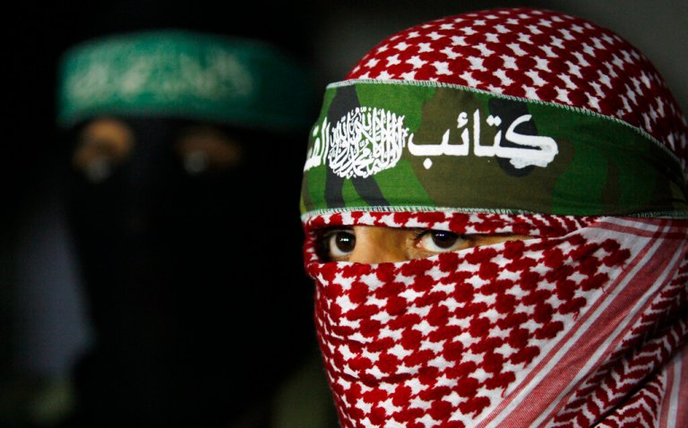 Abu Obeida, center, spokesman for the Qassam Brigades, Hamas's military wing, holds a press conference.