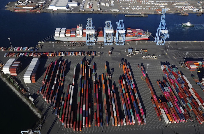 FILE - In this March 5, 2019, file photo, cargo containers are staged near cranes at the Port of Tacoma, in Tacoma, Wash. Most economists were already worried that the odds of a recession are rising,