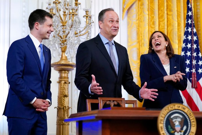 Vice President Kamala Harris, right, laughs as her husband Doug Emhoff, center, responds to a question from first lady Jill Biden as she speaks during an event to celebrate Pride Month in the East Room of the White House, Wednesday, June 15, 2022, in Washington. Transportation Secretary Pete Buttigieg listens at left.