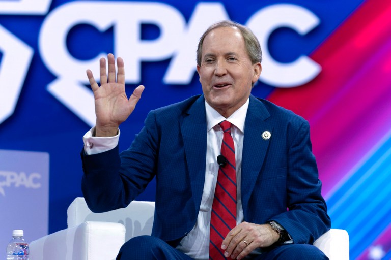 Paxton smiles and waves at CPAC 2024.