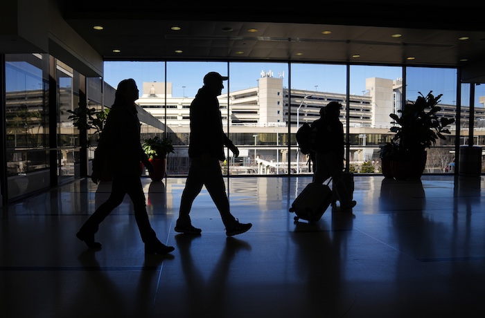 Travelers walk through Philadelphia International Airport in Philadelphia, Friday, Feb. 16, 2024.