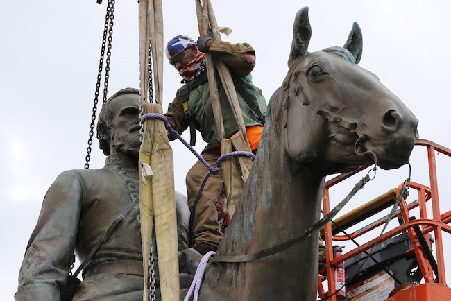 A worker attaches a rope to a statue of Confederate Gen. Stonewall Jackson.