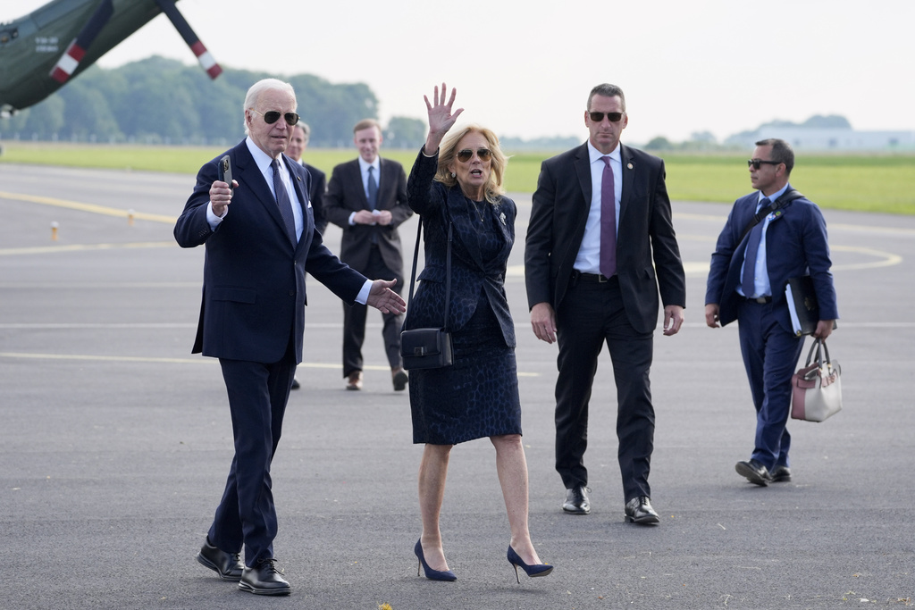 President Joe Biden and first lady Jill Biden walk to board Air Force One at the Caen-Carpiquet Airport.