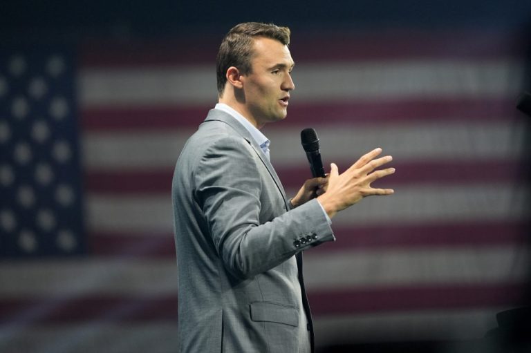 Turning Point USA Founder Charlie Kirk speaks into a microphone.