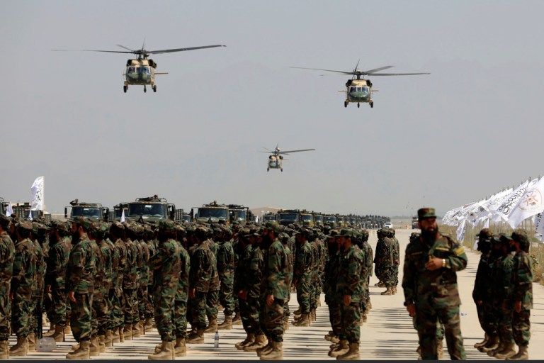 UH-60 Black Hawk helicopters fly during a military parade.