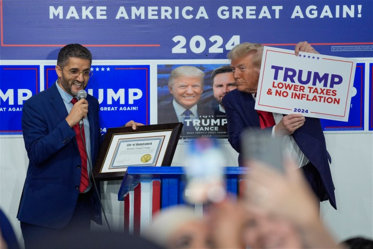Hamtramck Mayor Amer Ghalib speaks as Republican presidential nominee former President Donald Trump listens at a campaign office, Friday, Oct. 18, 2024, in Hamtramck, Mich.