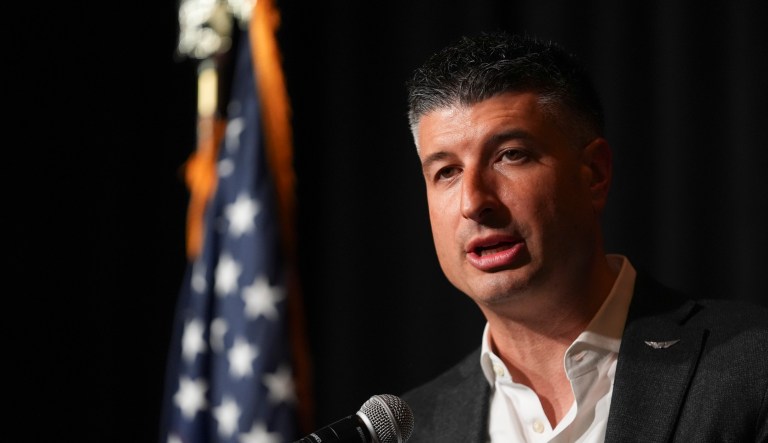 Michigan Republican congressional candidate Tom Barrett speaks into a microphone.