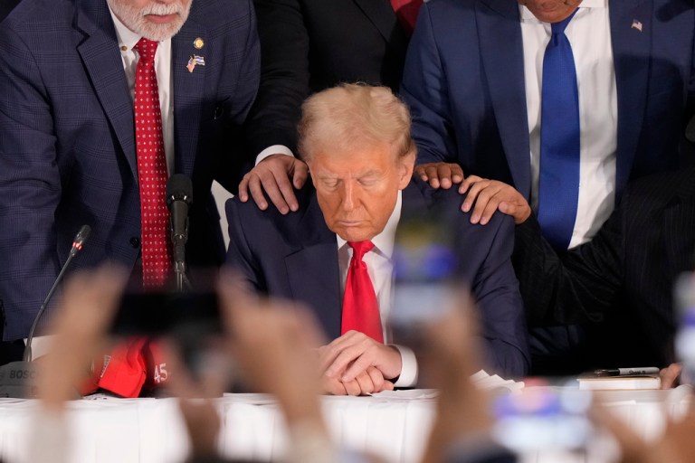 Latino leaders pray with former President Donald Trump.
