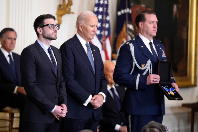 President Joe Biden presents the Presidential Medal of Freedom to Alex Soros on behalf of his father George Soros.
