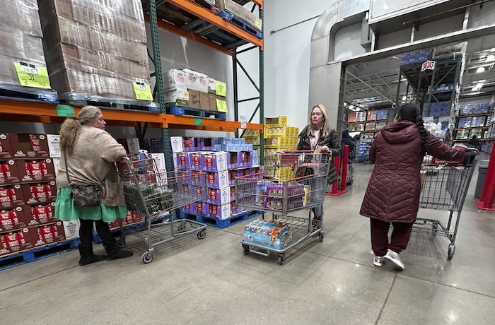 FILE - Shoppers guide their carts through the milk display in a Costco warehouse Thursday, Jan. 23, 2025,