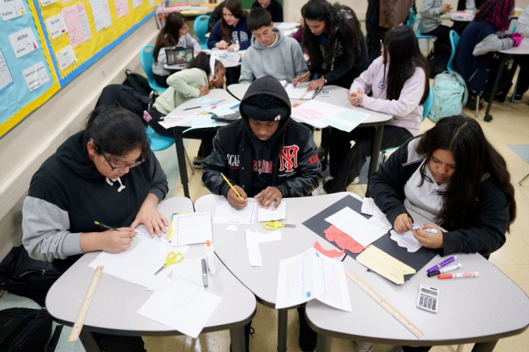 Students work in a classroom.