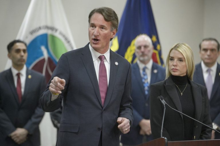 Governor Glenn Youngkin talking and pointing while standing next to Attorney General Pam Bondi