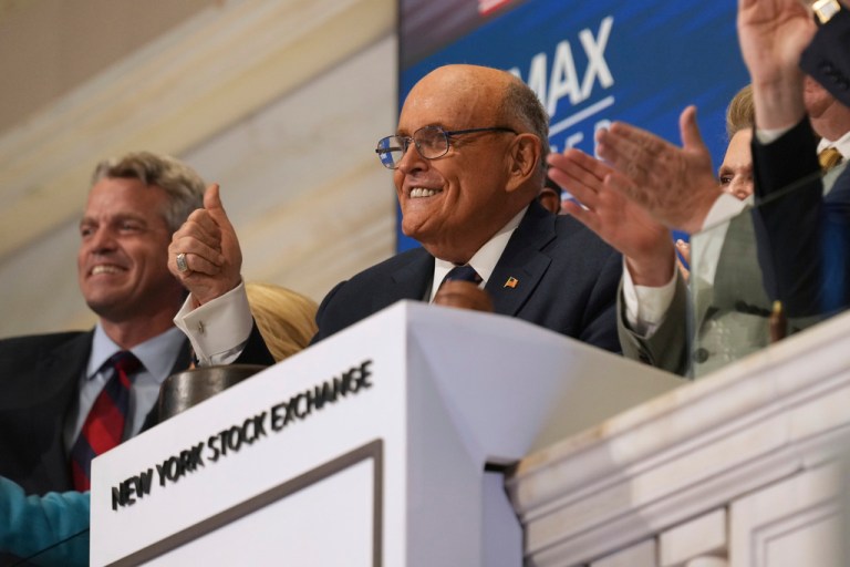 Former New York City Mayor Rudy Giuliani rings the bell with a group from Newsmax at the New York Stock Exchange.