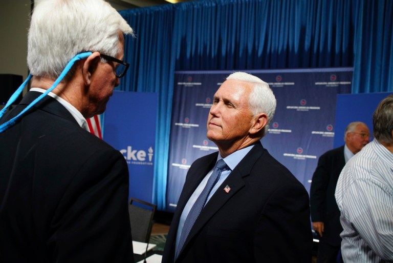 Former Vice President Mike Pence speaks with businessman H.O. Woltz III.