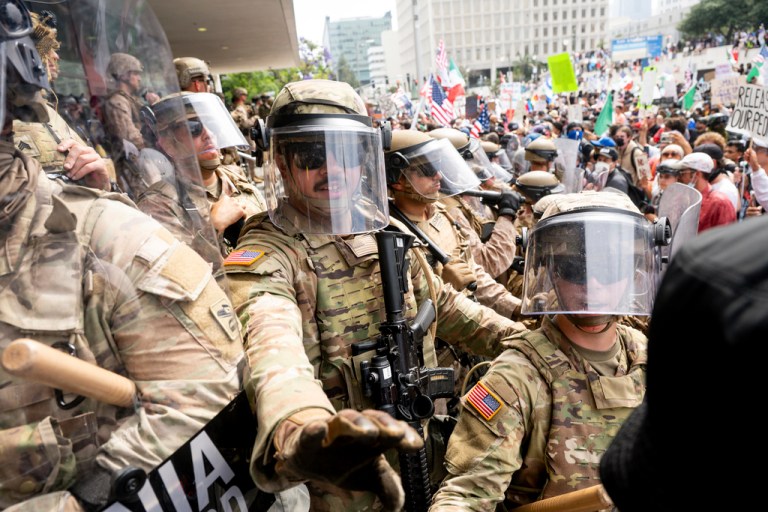 California National Guard and Marines hold back demonstrators at the Federal Building during a protest Saturday, June 14, 2025, in Los Angeles.
